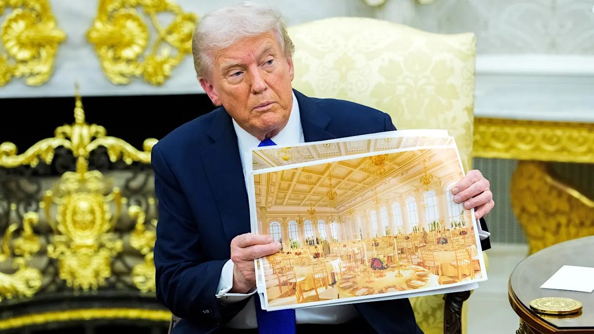 President Donald Trump shows off architectural designs for the future White House Ballroom during a public appearance.