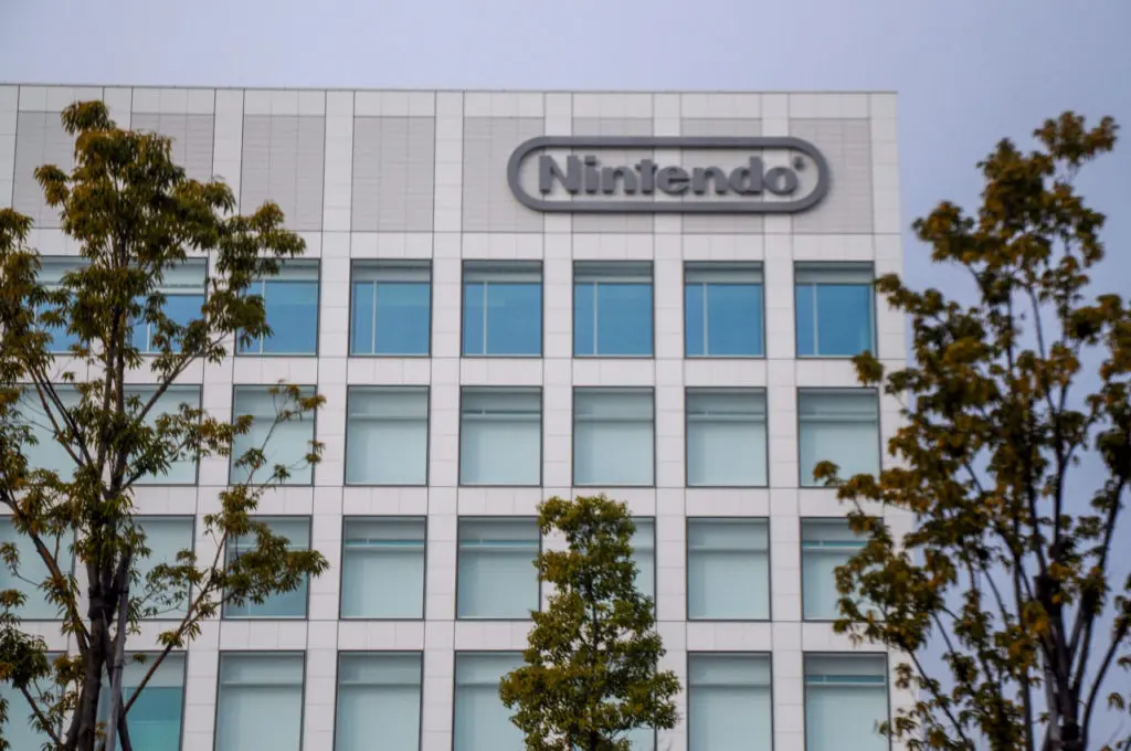 The Nintendo headquarters building in Kyoto with the logo on top.