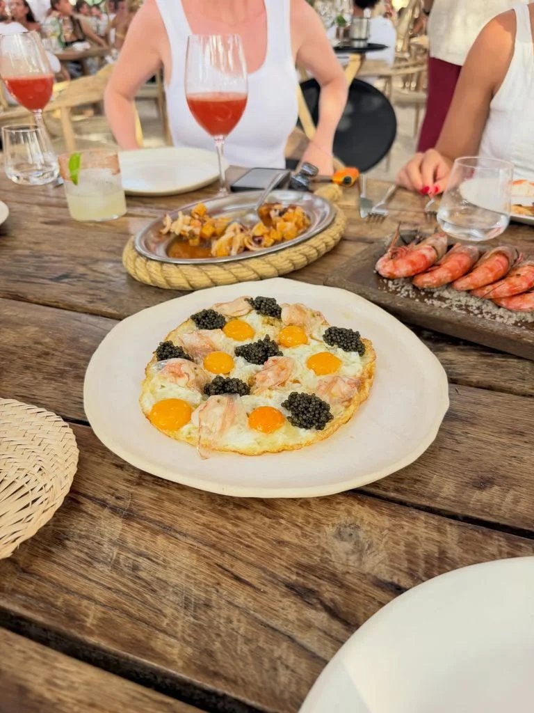 Eggs with shrimp, bacon and caviar, one of the signature dishes of a fashionable restaurant in Ibiza.
