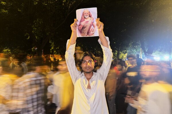 Indian 'Cockroach' protesters use memes and humor to challenge Modi 17 A protester holds a poster with a portrait of Indian Prime Minister Narendra Modi, dressed in a sari, the traditional dress for women in India, during a demonstration demanding education reform as part of the ongoing Cockroach Janta Party protest movement in New Delhi, India, Thursday, July 23, 2026. (AP Photo/Verda Subzwari)