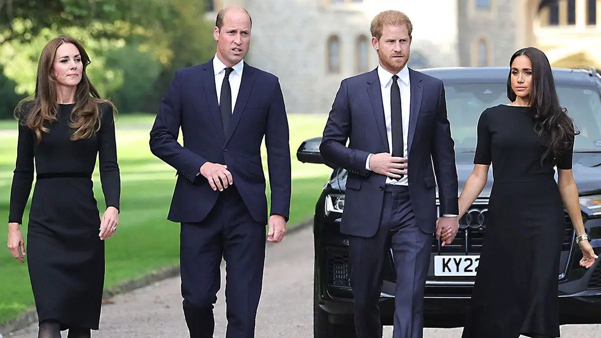 Kate Middleton, Prince William, Prince Harry and Meghan Markle walk together in matching dark suits in the UK.