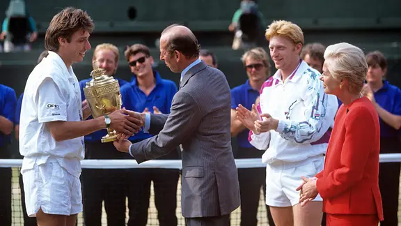 Prince Charles hands the Wimbledon trophy to Michael Stitch in 1991.