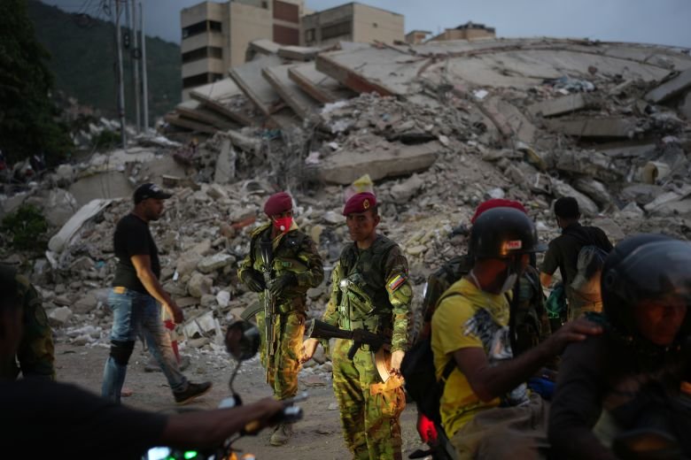 Soldiers guard an area damaged by an earthquake in La Guaira, Venezuela, Saturday, June 27, 2026.