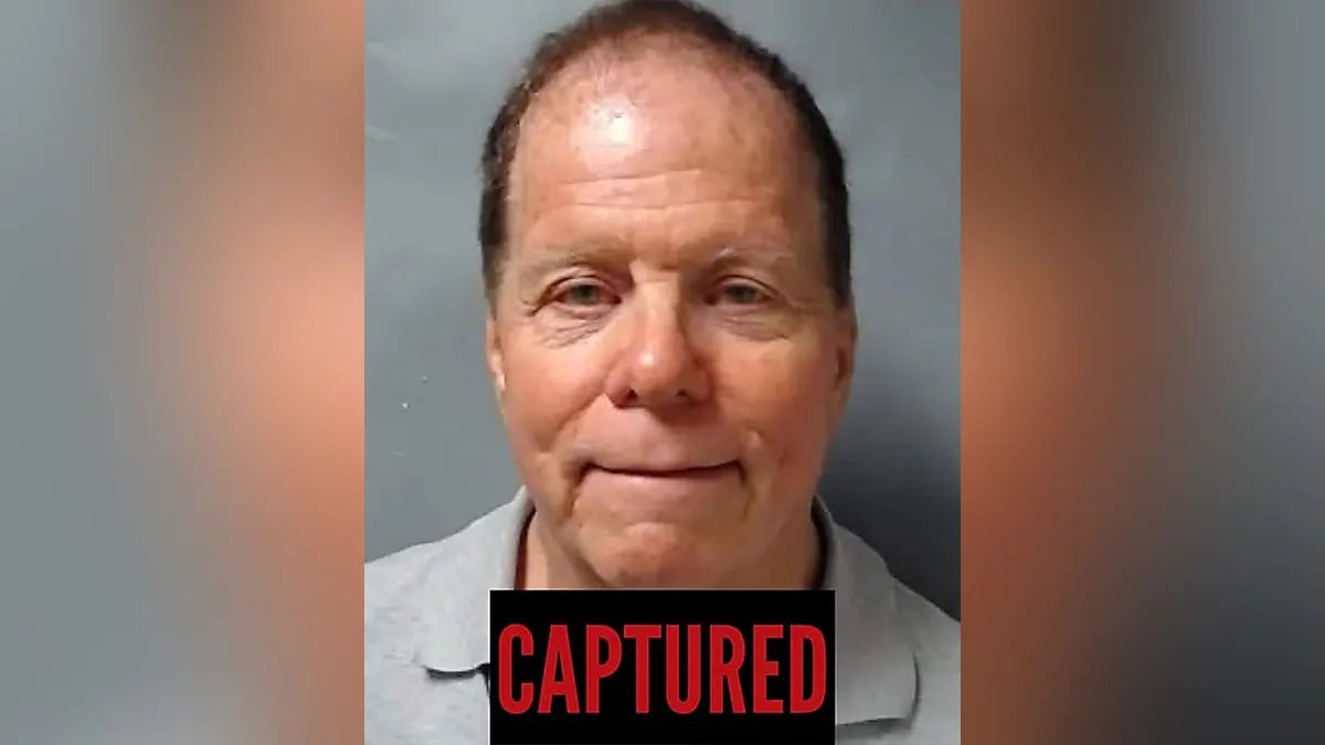 America's Most Wanted's Ronald Fisher Captured on a Sailing Boat in New Jersey 13 A recent booking style photo of Ronald L. Fisher in a black suit.