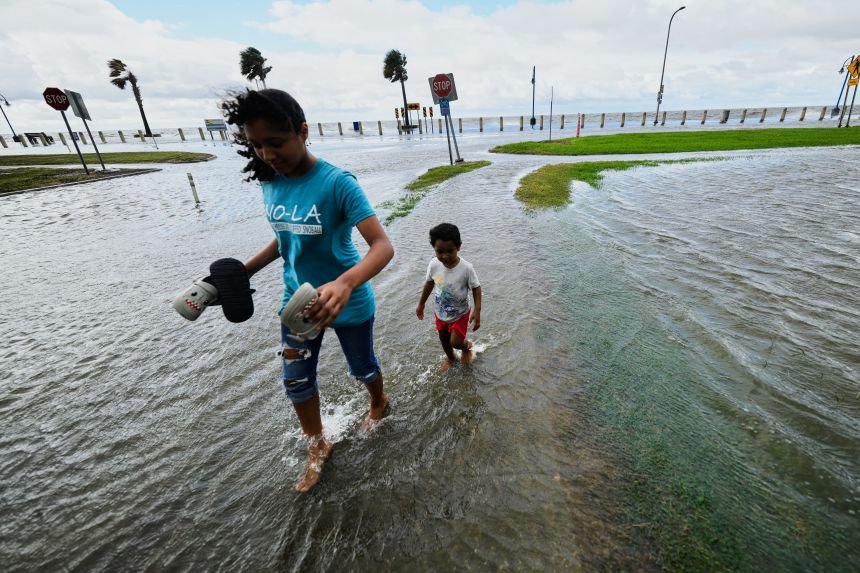 Bertha weakens to a tropical depression, but its moisture remains, increasing the threat of flooding to the east. 11 Residents walk through floodwaters along Lake Pontchartrain in New Orleans as Tropical Storm Bertha approaches the Louisiana coast on Wednesday, July 22.
