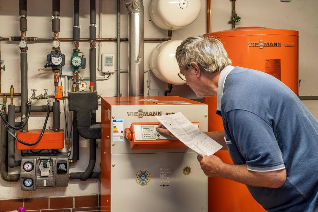 A pensioner checks his old gas heater with hot water tank in the boiler room, Arnsberg, July 11, 2026.