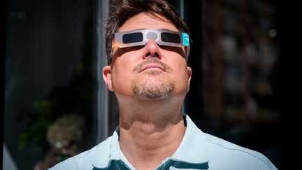A man wears certified eclipse glasses on July 2, 2026 in Burgos, Spain. (CESAR MANSO/AFP)