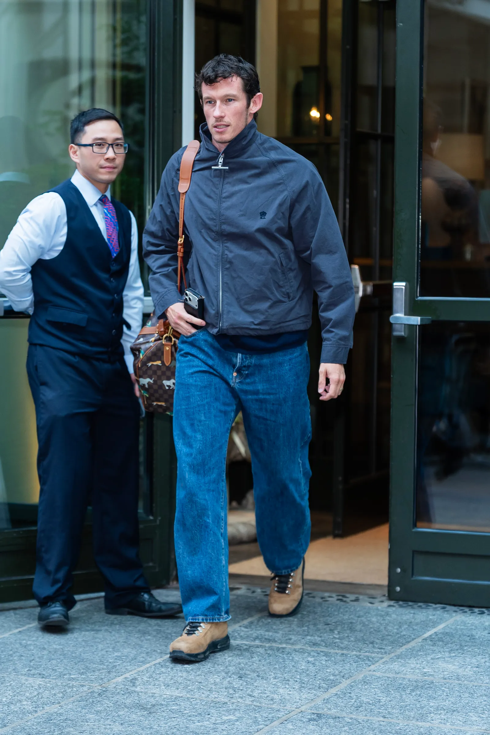Callum Turner's Nikes are ready for the apocalypse 12 Image may contain Callum Turner Clothing Trousers Jeans Coat Jacket Face and head of an adult