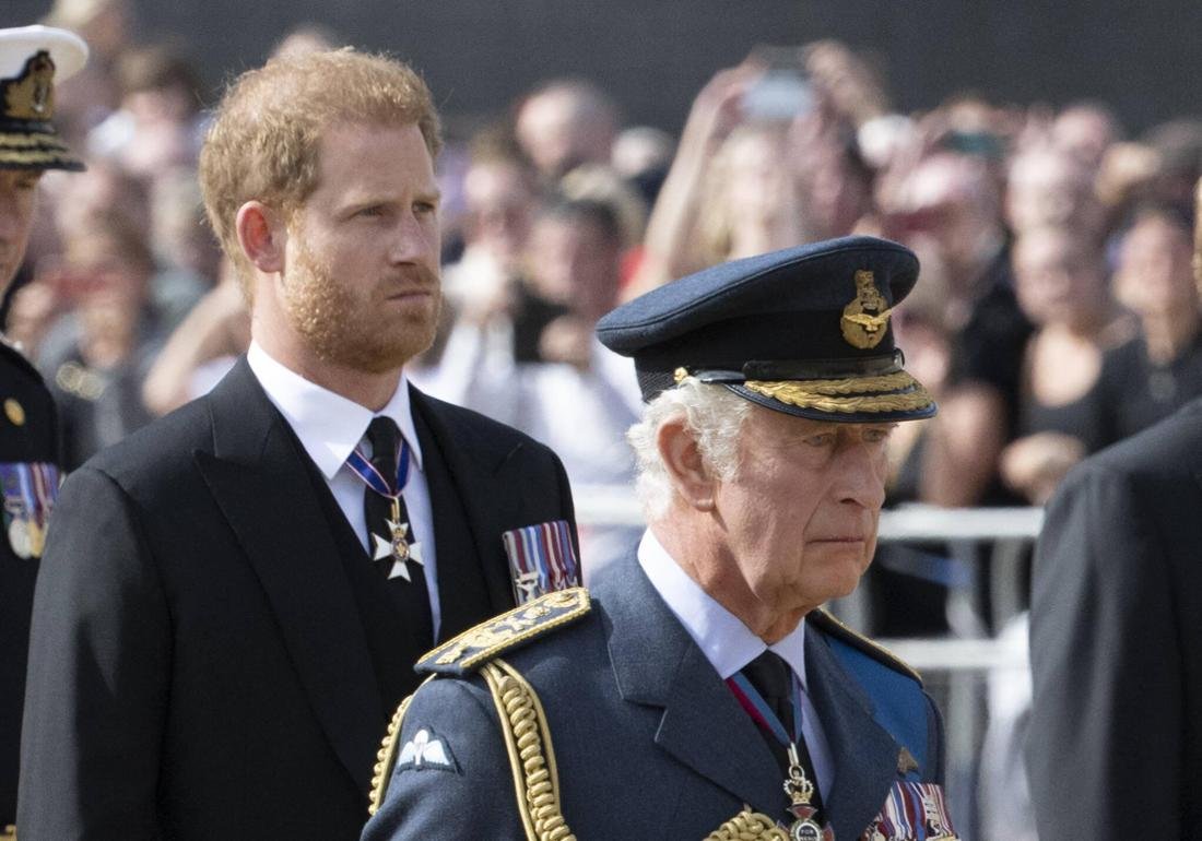 King Charles and Prince Harry behind him