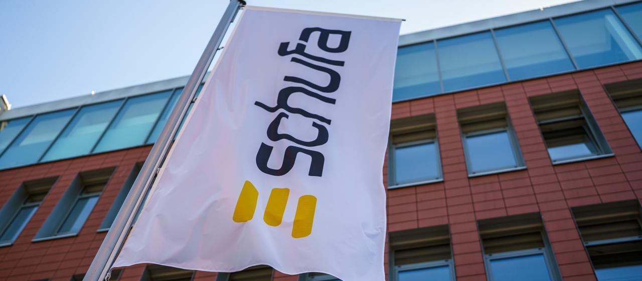 A flag bearing the Schufa company logo flies in front of the company's headquarters in the state capital. | dpa A flag bearing the Schufa company logo flies in front of the company's headquarters in the state capital.