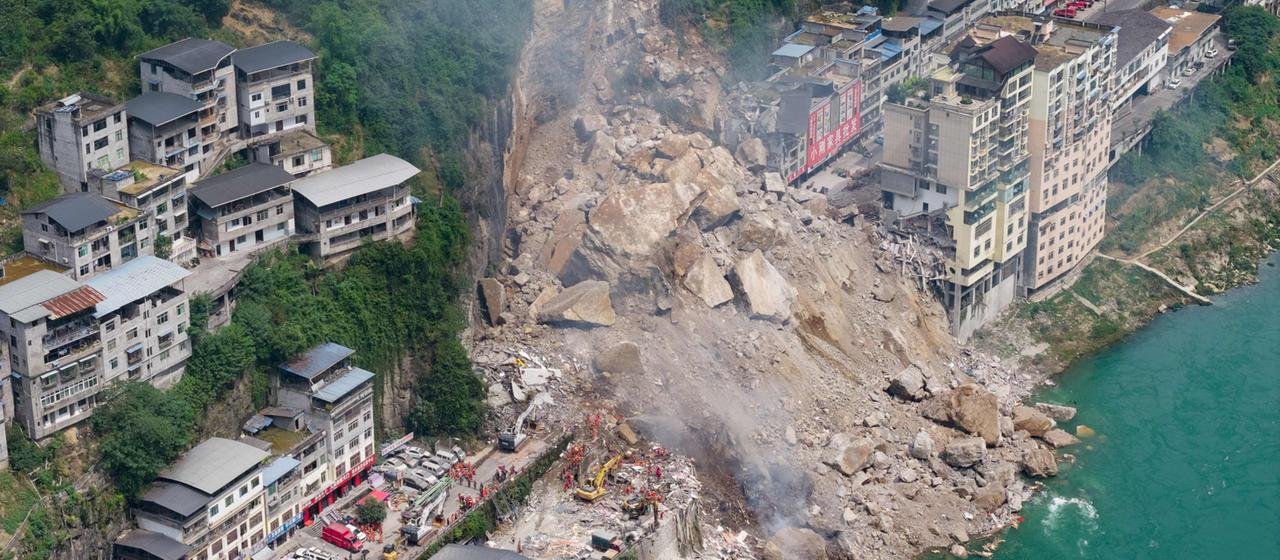 Rescuers work near a landslide in the Pengshui region of China.