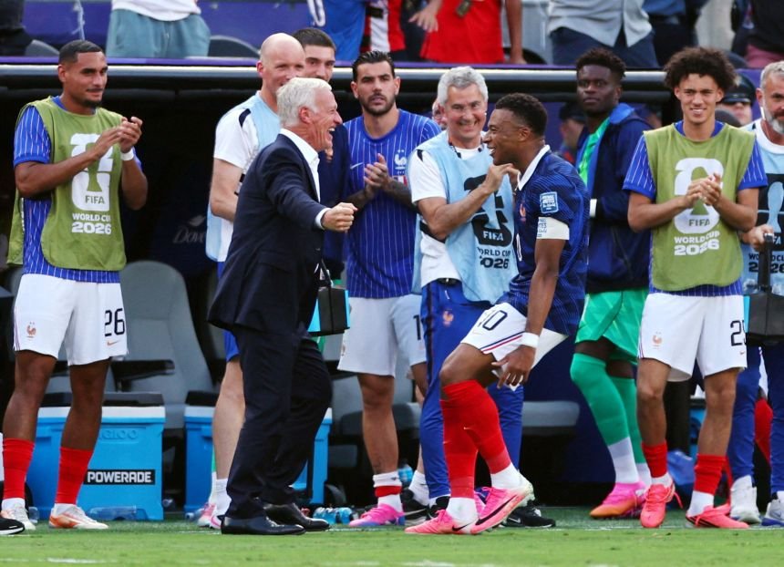Frenchman Kylian Mbappe celebrates his first goal with his coach at New York/New Jersey Stadium on June 30.
