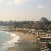 A beach in Lima, Peru, is bathed in unseasonal winter sunshine, scientists predict. 