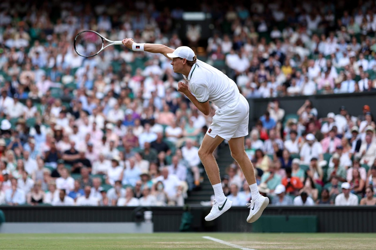 Jannik Sinner makes his way through Wimbledon, and familiar enemies await him 11 Jannik Sinner finishes his serve in the air with the crowd behind him.