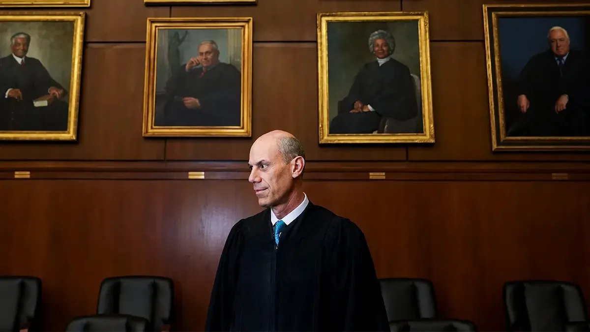 Judge James E. Boasberg, chief judge of the Federal District Court for the District of Columbia, stands at a portrait in the E. Barrett Prettyman Federal Courthouse in Washington, D.C., March 16, 2023. (Photo by Carolyn Van Houten/The Washington Post via Getty Images)