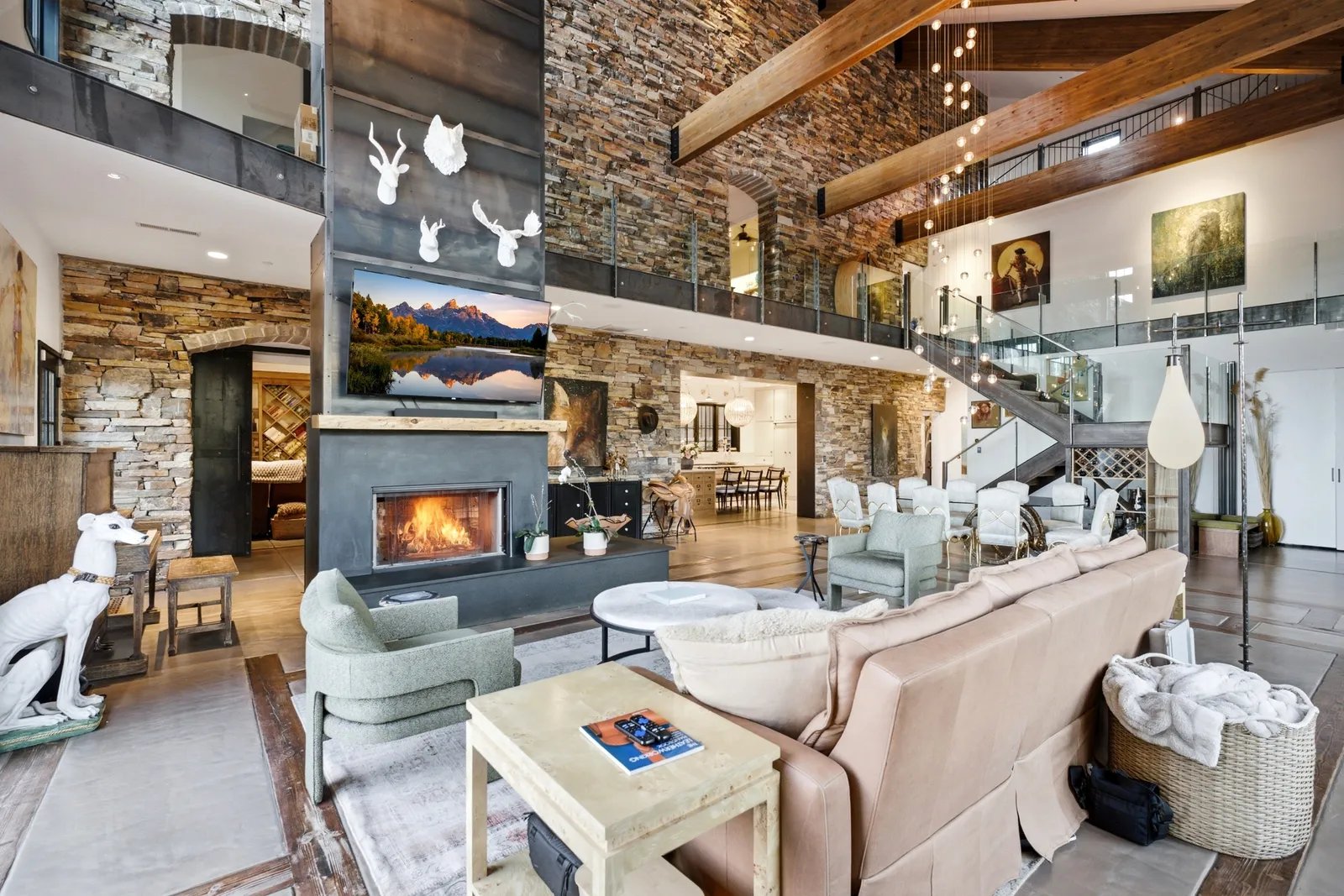Katherine Heigl has put her 25-acre estate in the Utah mountains up for sale for $10.6 million. 12 living area of Katherine Higgles Utah home with stone wall, large beams, vaulted ceiling, fireplace, white wildlife...