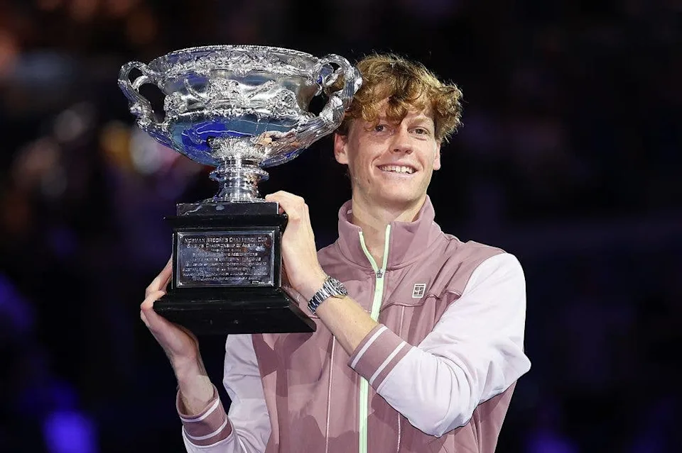 Jannik Sinner of Italy poses with the Norman Brookes Challenge Cup during the official presentation after the 2024 Australian Open men's singles final.