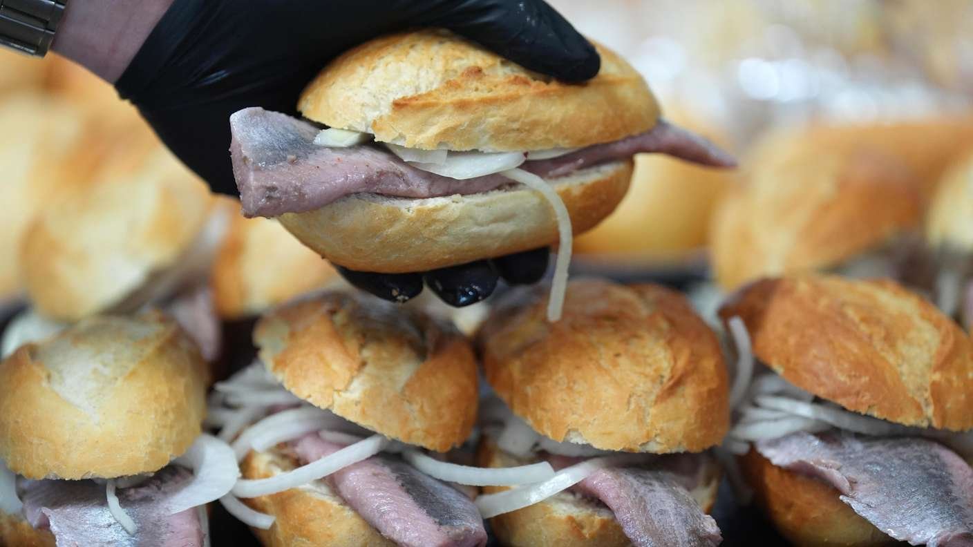 Sandwich with fish in hand 