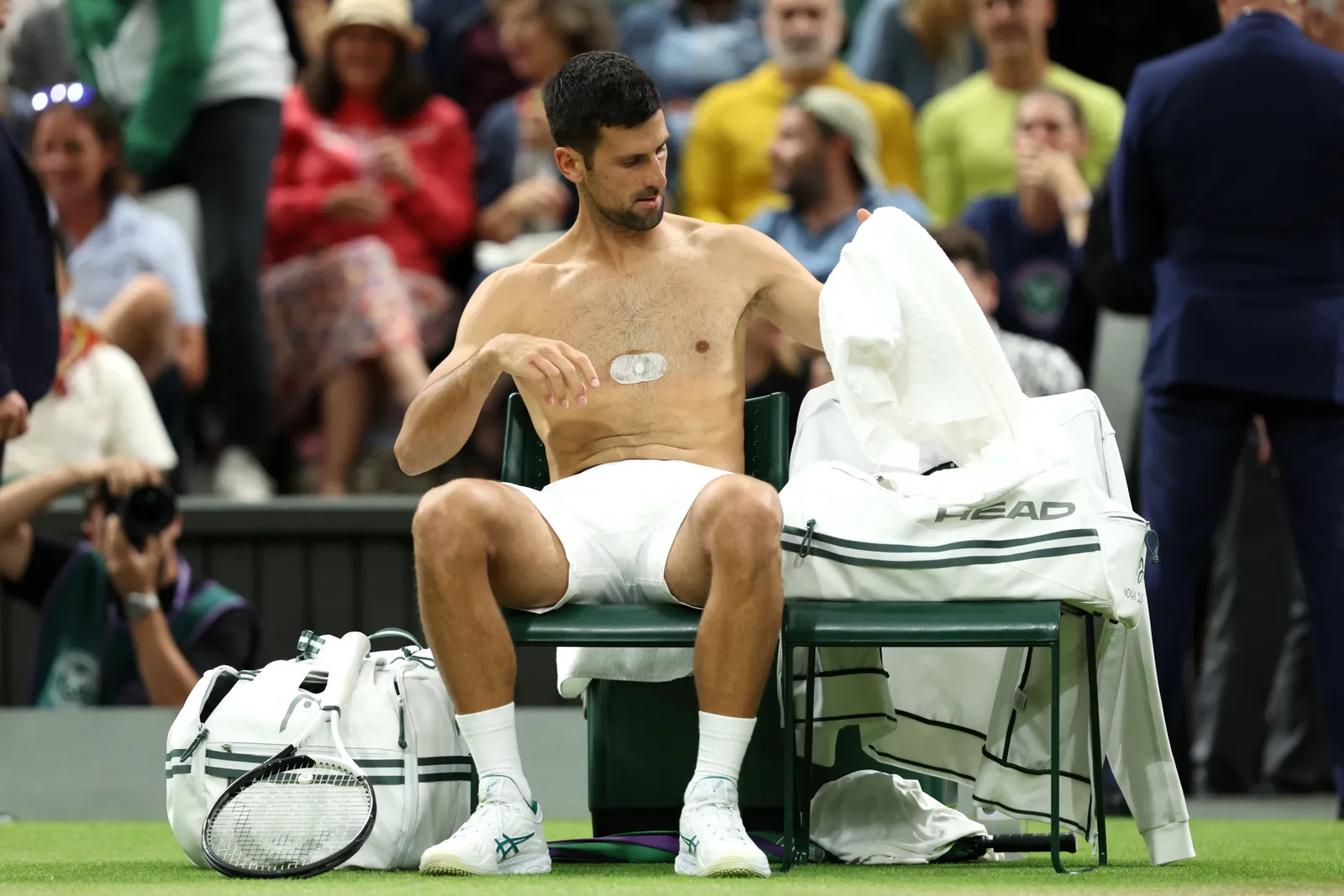 LONDON, ENGLAND, JULY 9 Novak Djokovic of Serbia changes his jersey during a break against Hubert Hurkacz of Poland.