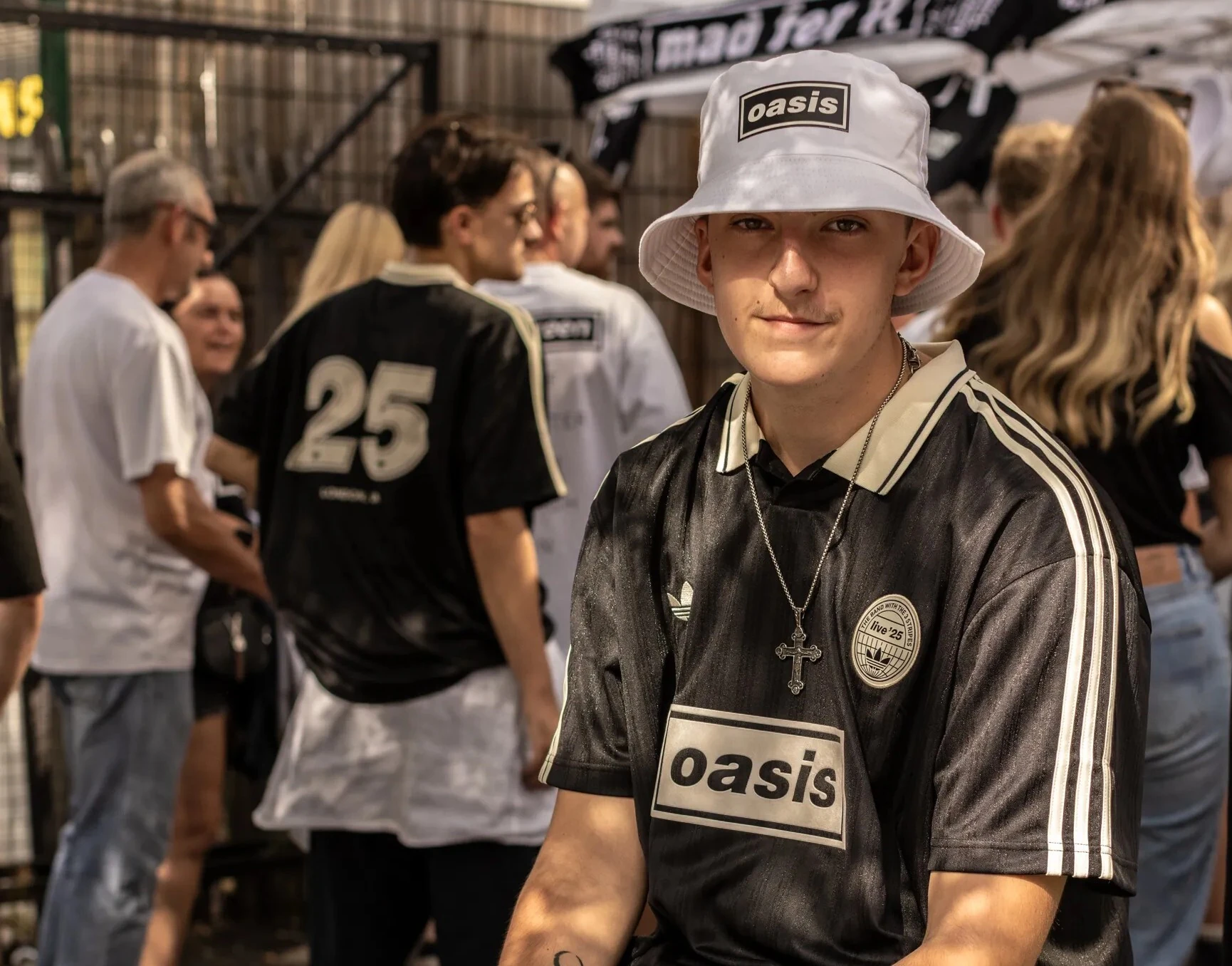 Oasis Tour 2027: Everything we know about Manchester residency rumors and Knebworth dates 12 Oasis fan outside the merchandise stall at Wembley Stadium