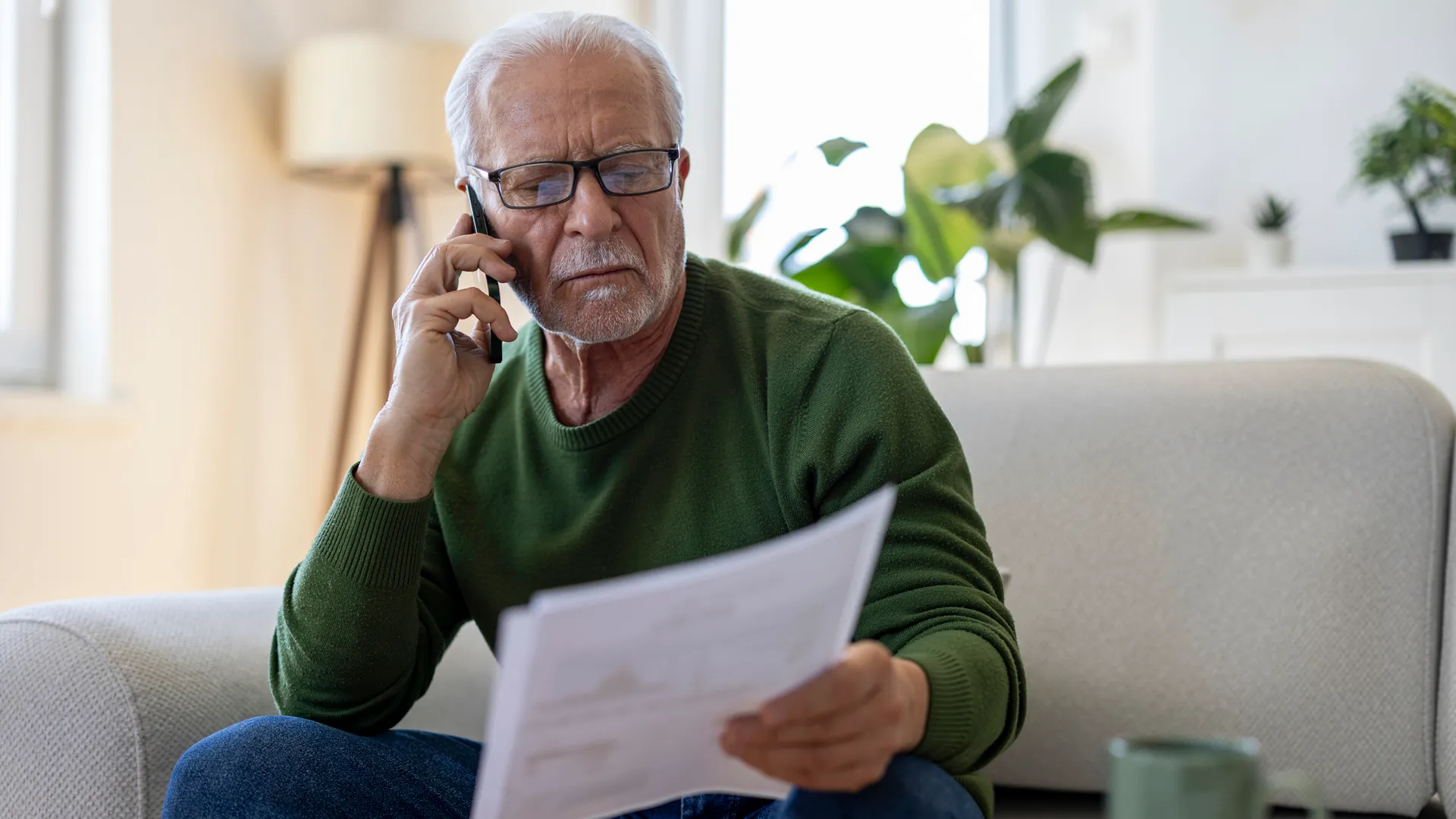 A pensioner reads a letter: The Deutsche Post pension service is sending an important letter these days. A pensioner reads a letter: The Deutsche Post pension service is sending an important letter these days.