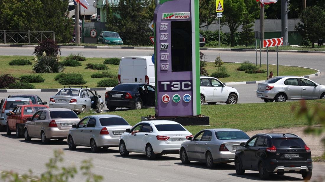Cars line up around fuel gauges