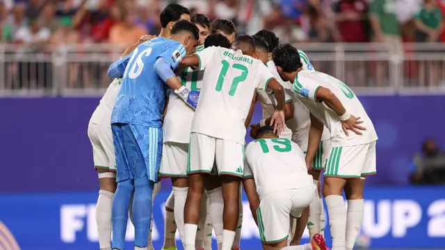 Algeria players huddle together