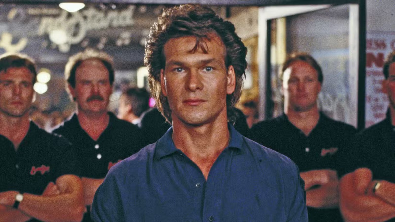Patrick Swayze's Dalton looks closely in Road House