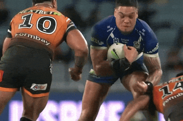 Tackle by Latu Fainu against Leo Thompson.