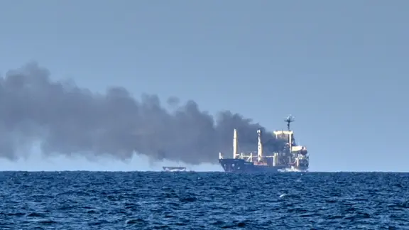 After a Russian missile attack in the Black Sea, smoke rises from the Guinea-Bissau-flagged grain carrier Golden Leo.