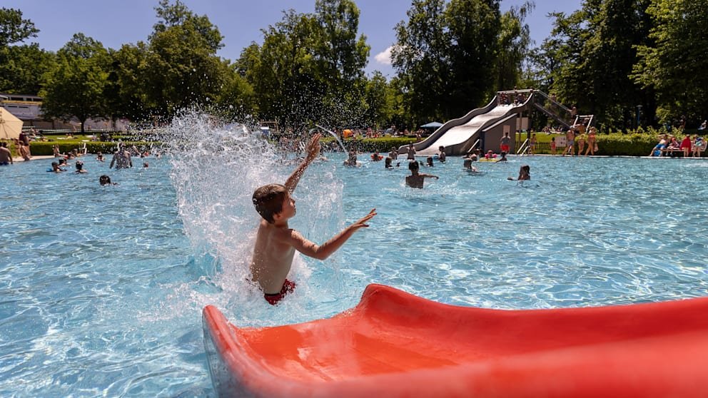 A child rides in an outdoor pool. There's likely to be a nice cool down this weekend, especially in the southwest.