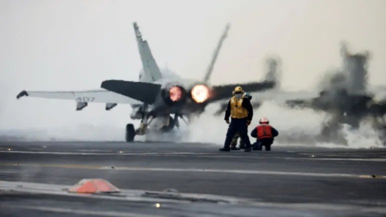 A US Navy F-18 fighter takes off from the deck of an aircraft carrier (Reuters)