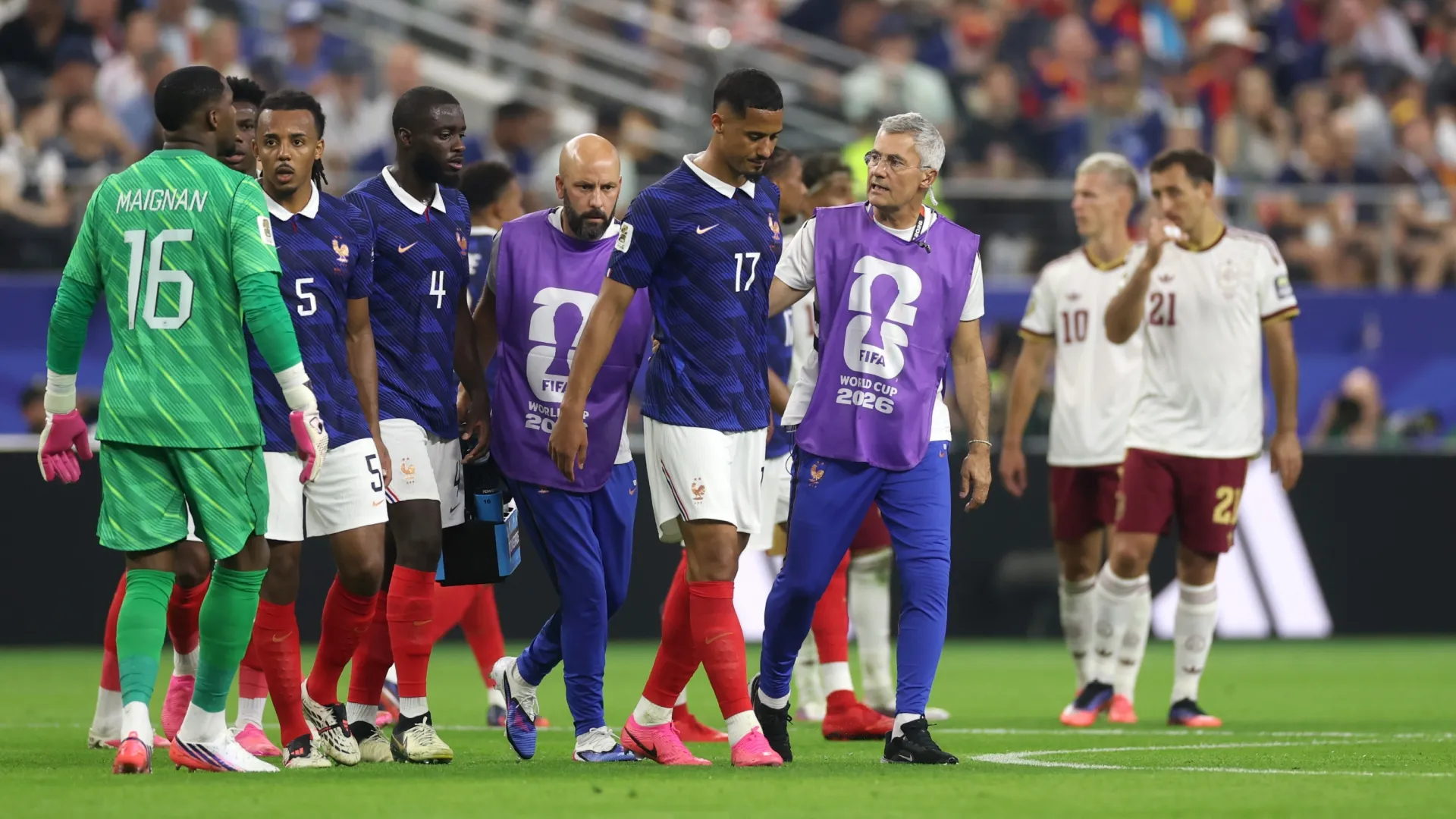 William Saliba (No. 17) of France leaves the field with medical staff after being injured. Lars Baron/Getty Images