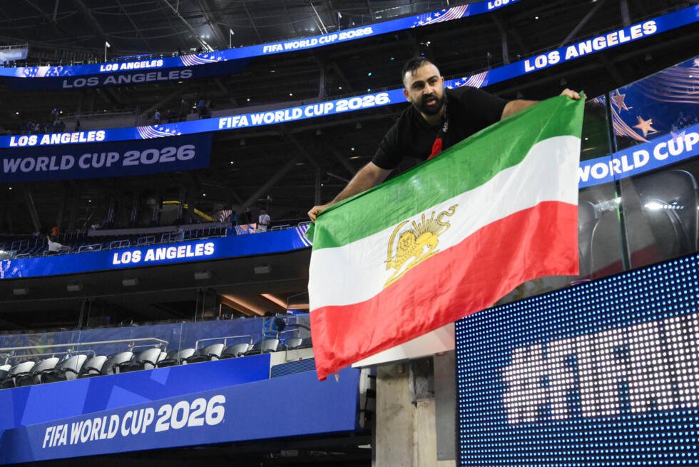 A fan carries an old Iranian flag in Los Angeles.
