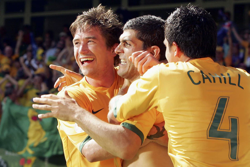 World Cup: The Socceroos aren't the only ones chasing history when they face Egypt in Dallas 13 Three Socceroos celebrate each other.