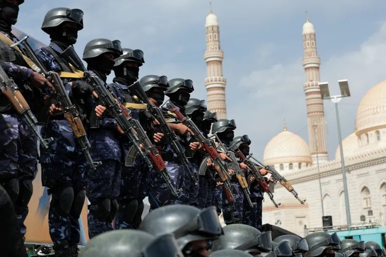 Houthi security forces stand guard in Yemen's capital Sanaa as Houthi supporters rally against Saudi-led coalition restrictions on Houthi-controlled areas that the group calls a blockade, July 17, 2026.