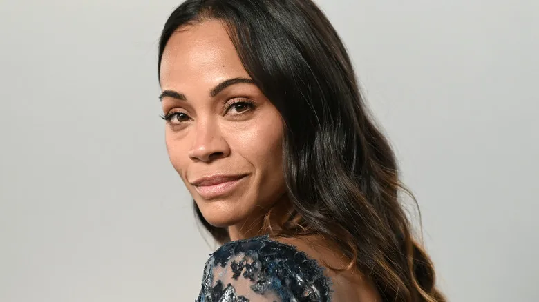 Zoe Saldaña's advice to her younger self is to love what's in the mirror 11 Zoe Saldaña smiles on the red carpet in 2026